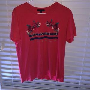 a reddish shirt with print on the front